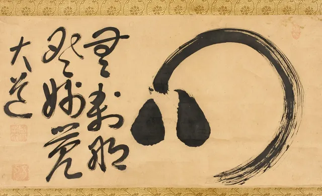 A single circular brushstroke in black ink, which is also the character for heart-mind, on a hanging scroll with a brocade mount.
