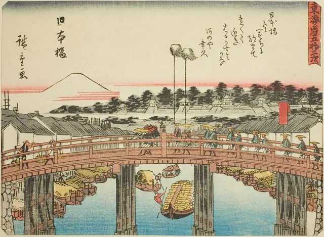 The arched wooden Nihonbashi bridge in Edo crowded with people, boats on the river below and Mount Fuji white in the distance.