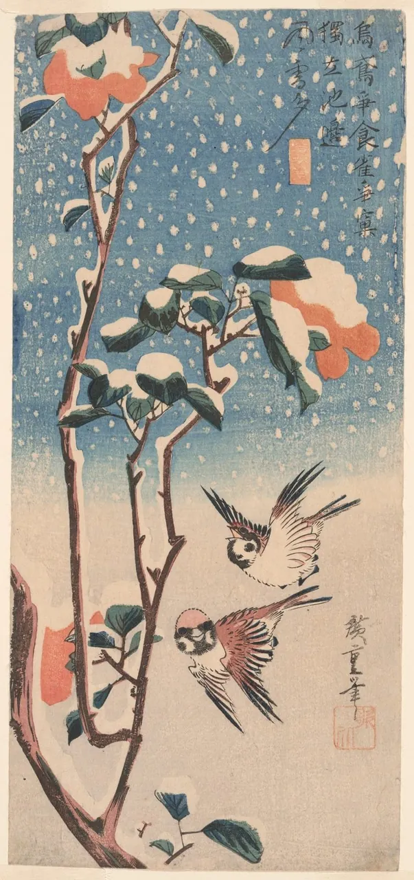 Two sparrows fly beside a snow-covered camellia branch with red flowers while snow falls against a blue ground.