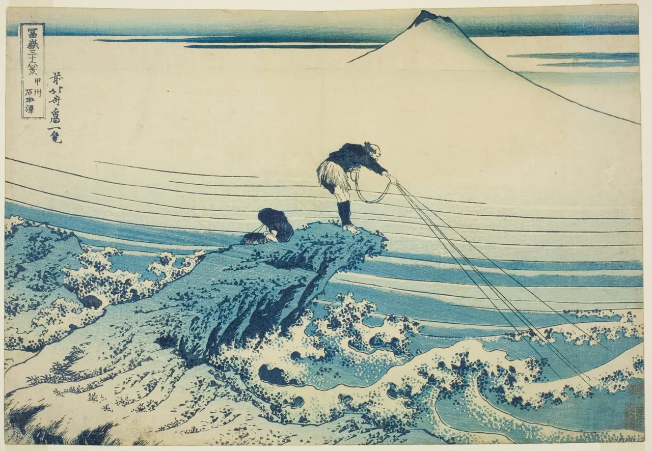A fisherman stands on a rock above churning blue waves and casts his lines, with a boy beside him and Mount Fuji in the mist behind.