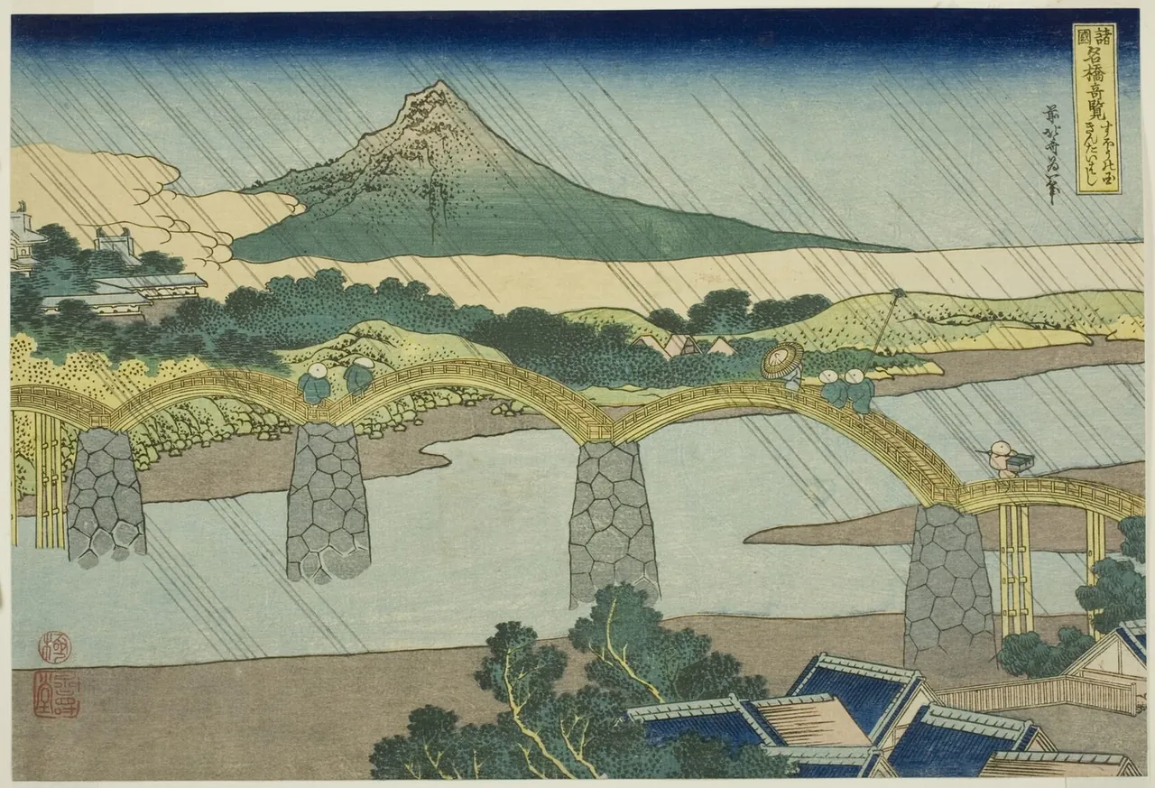 A wooden bridge of several high arches crosses a wide river on stone piers in light rain, with a green mountain behind.
