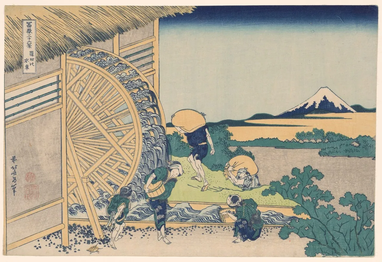 A large wooden waterwheel turns beside a mill while villagers wash and carry grain in the stream, with Mount Fuji small in the distance.