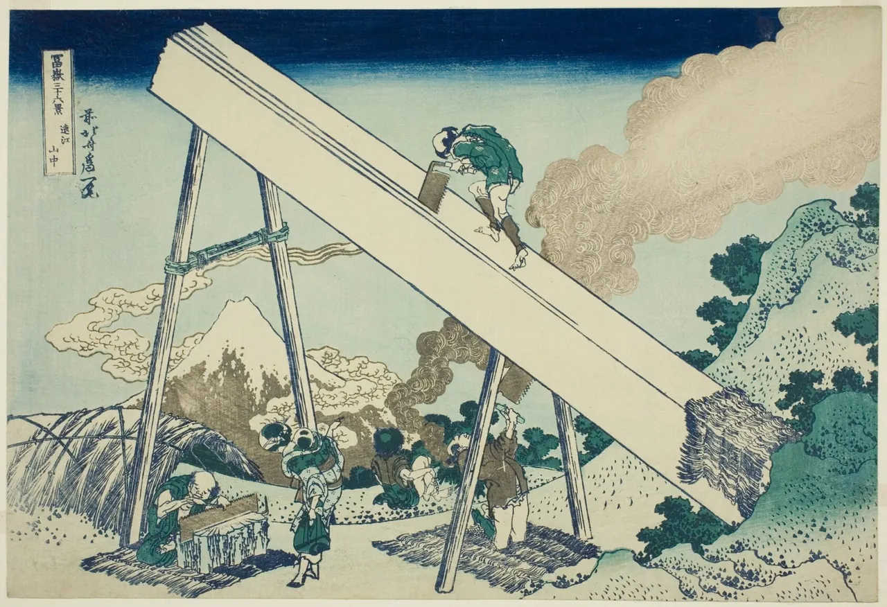 Two sawyers cut a huge timber propped on a tall frame, one standing on top and one working underneath, while Mount Fuji shows through the smoke.