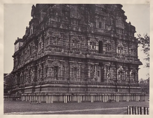 A sepia photograph of the carved granite walls and rising tower of the Brihadeshvara temple at Thanjavur.
