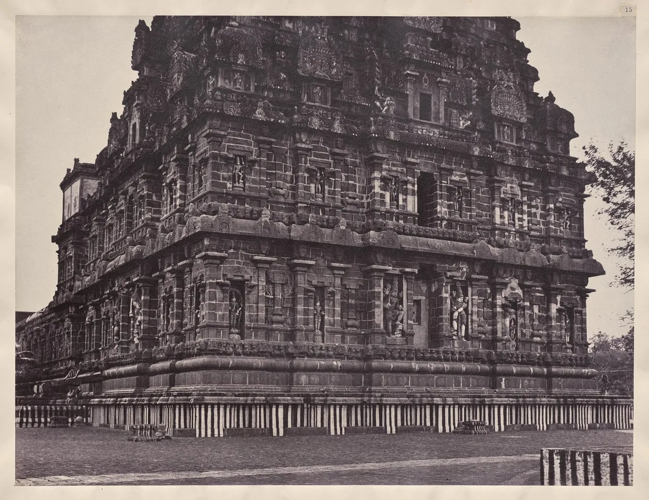 A sepia photograph of the carved granite walls and rising tower of the Brihadeshvara temple at Thanjavur.